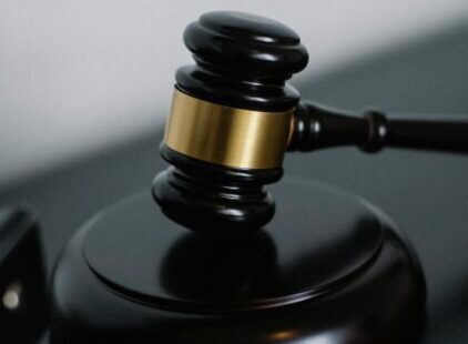 Close-up of a wooden gavel on a desk, symbolizing justice and legal authority.